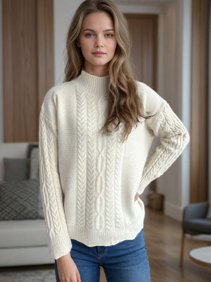 Cream cable knit mock neck sweater with textured details and long sleeves.