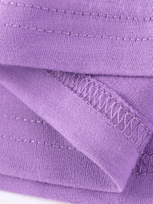 Purple cotton toddler dress detail showing stitching and fabric texture.