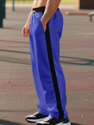 Men's royal blue wide-leg sweatpants with black side stripe and drawstring.
