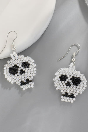 Beaded skull earrings in white with black accents.
