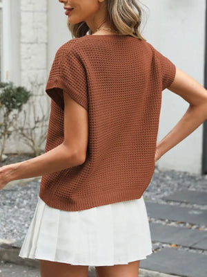 Relaxed openwork knit top in apricot with short sleeves and a crew neck.