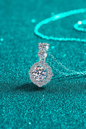 Halo moissanite pendant necklace in sterling silver with a delicate chain.