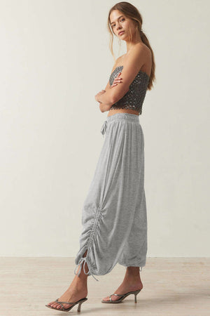 Gray gathered ankle-tie balloon trousers with a drawstring waist and ruched detail
