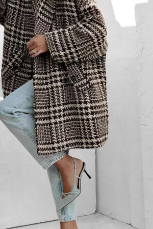 Oversized houndstooth cocoon coat in black and brown with button closure.