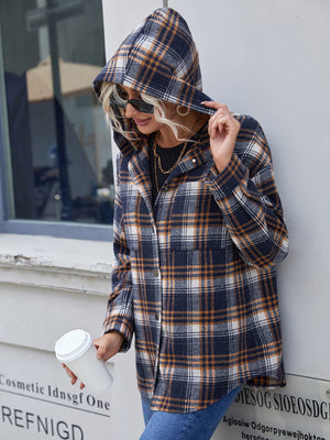 Plaid hooded shacket in navy with white and orange. Relaxed fit, buttoned front, and chest pockets.