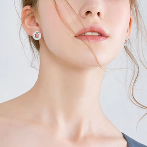 Silver pavé circle stud earrings with a delicate, open design.