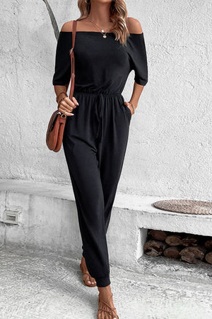 Black off-shoulder jumpsuit with drawstring waist and cuffed ankles