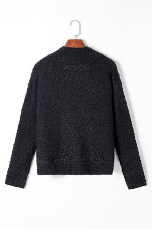 Black textured bouclé open-front jacket with a rounded neckline and long sleeves.