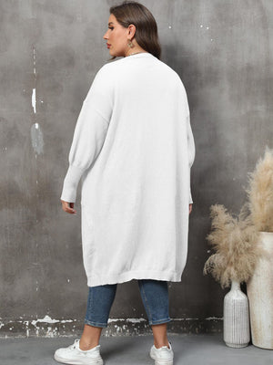 White oversized knit duster cardigan with patch pockets and ribbed cuffs.