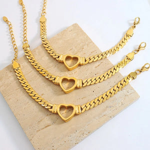 Gold curb chain bracelet with heart link detail, 18K gold-plated
