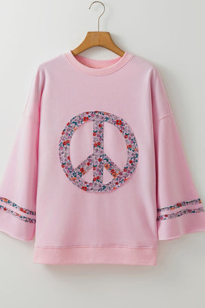 Dusty pink sweatshirt with floral peace sign applique and sleeve detail.