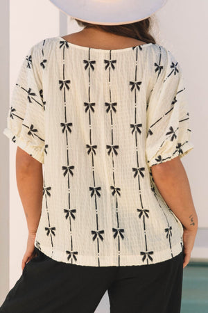 Beige gauze blouse with black bow print and gathered sleeves