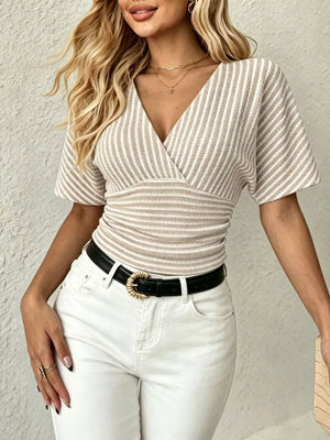 Chic striped surplice t-shirt with smocked waist and batwing sleeves in beige and white.