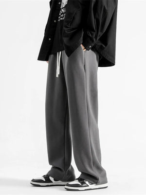 Dark gray casual loose fit sweatpants with white drawstring and pockets.