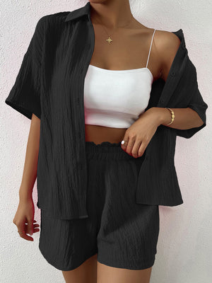 Black textured resort shirt and shorts set with button details.