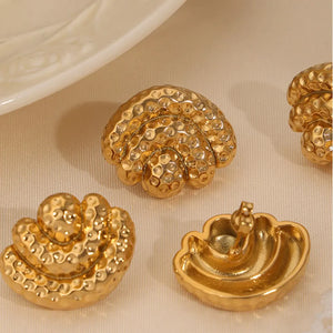 Gold textured shell stud earrings with a hammered finish.