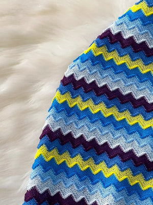 Chevron knit halter crop top in blue, yellow, and purple stripes.