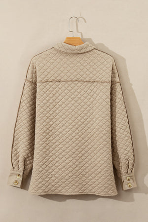 Diamond quilted beige oversized button-up jacket with raw edge detail and button cuffs.