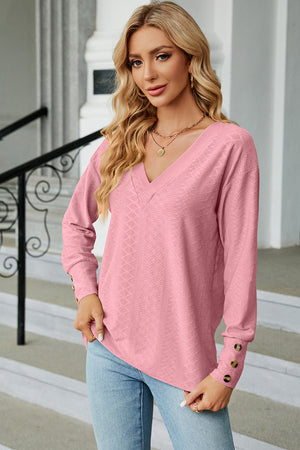 Blush pink diamond-textured V-neck blouse with button cuff detail