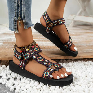 Camouflage platform trek sandals with adjustable straps and colorful beaded anklet.