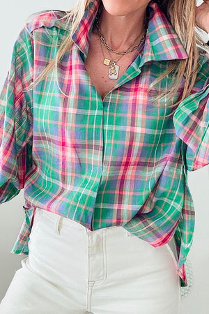 Voluminous plaid blouse with gathered sleeves in green, pink, and purple plaid.