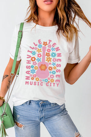 White t-shirt with Nashville Tennessee Music City graphic featuring a pink guitar and colorful flowers.