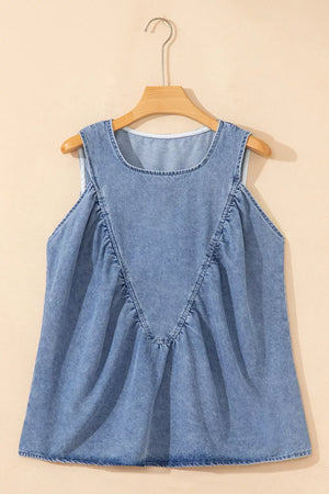 V-shaped pleated denim sleeveless top in light blue with a round neckline.