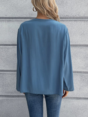 Dusty Blue long sleeve blouse with a relaxed fit, shown from the back.