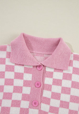 Pink checkerboard knit polo sweater with button front and collar.