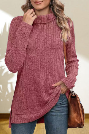 Ribbed knit turtleneck tunic top in cerise with long sleeves and a relaxed fit.