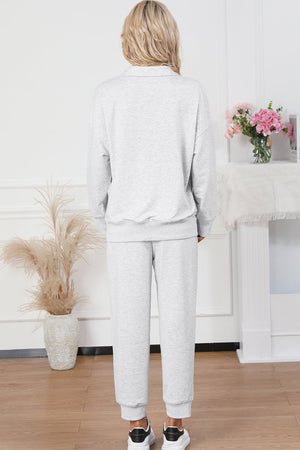 Light gray quarter-zip loungewear set with a collared neckline and cuffed joggers.