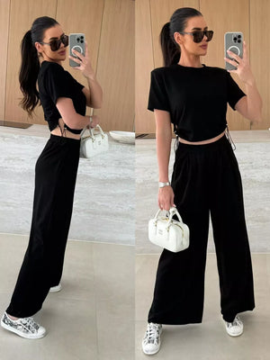Black crop top with drawstring sides and wide-leg pants set.