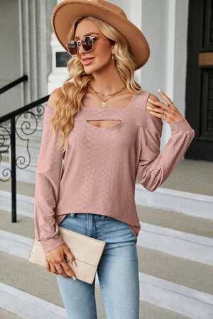 Blush pink textured open shoulder blouse with keyhole neckline and long sleeves.