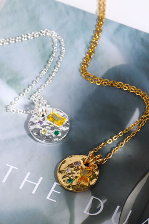 Gold and silver textured disc necklaces with colorful gemstone accents