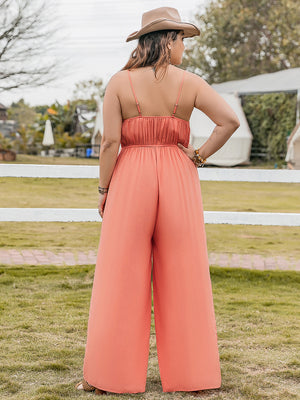 Orange embroidered bodice wide leg jumpsuit with spaghetti straps and a cinched waist.