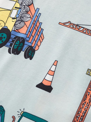 Toddler t-shirt with construction vehicle print, featuring a dump truck, crane, and traffic cone on a light blue background.