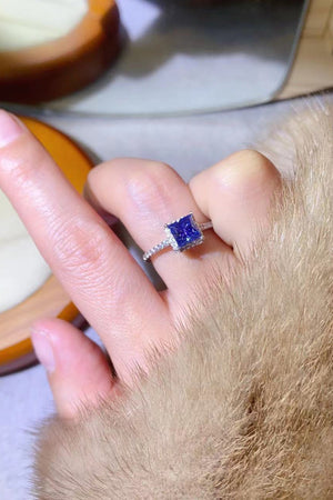 Blue square halo ring with pave band on finger