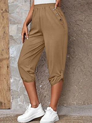 Camel culottes with button details and cuffed hems, styled with white sneakers.