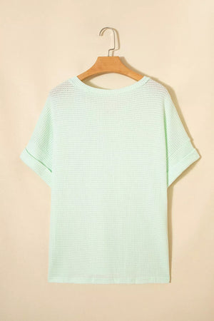 Light green waffle knit t-shirt with cuffed short sleeves and a relaxed fit.