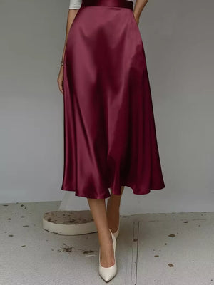 Elegant A-line satin skirt in wine red with pockets, midi length.