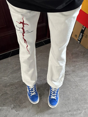 White casual sweatpants with red graphic print and text detail, men's fit.