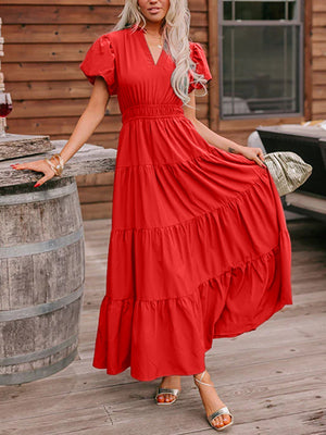 Deep red tiered maxi dress with puff sleeves and a V-neckline.