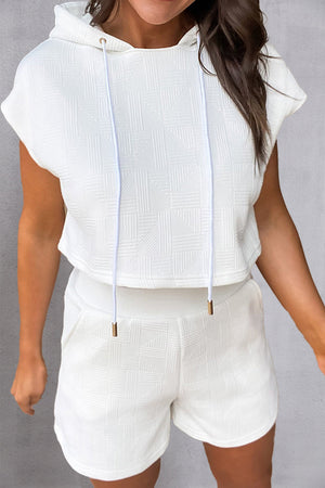 White textured crop hoodie with cap sleeves and matching shorts set.