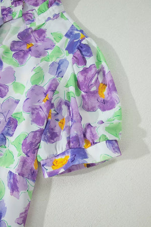 Vibrant floral mini dress with purple flowers, ruffled neckline, and puff sleeves.