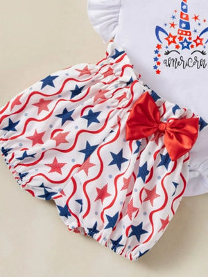 Baby outfit with white top and star print bloomer shorts, red bow detail