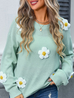 Mint green acrylic knit sweater with white daisy appliqués and balloon sleeves.