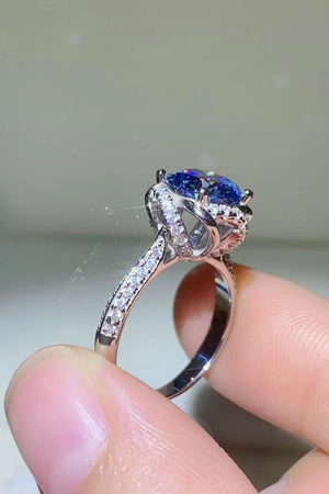 Blue moissanite halo ring with diamond band and silver setting