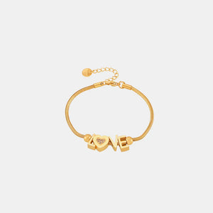 Gold adjustable bracelet with LOVE letter charms and a heart charm with pave details.
