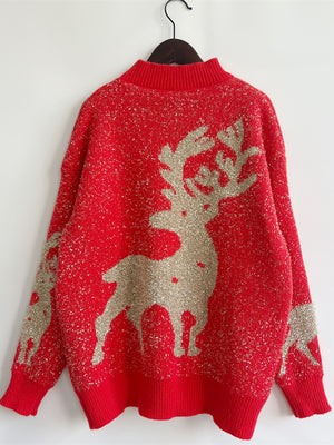 Red acrylic sweater with glittery reindeer pattern and mock neck.
