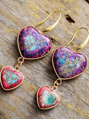 Heart stone cascade earrings with gold hooks and purple, blue, and pink marbled stones.